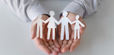 close-up-hands-holding-paper-people